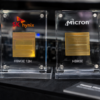 SK Hynix and Micron HBM3E memory chips displayed side by side at a technology showcase.