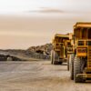 Super sized rock trucks take a load of platinum rich rock into the crusher.