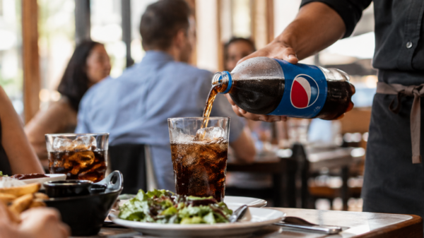 Pepsi being poured to glasses