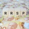 RRSP (Registered Retirement Savings Plan) on wooden blocks and Canadian one hundred dollar bills.